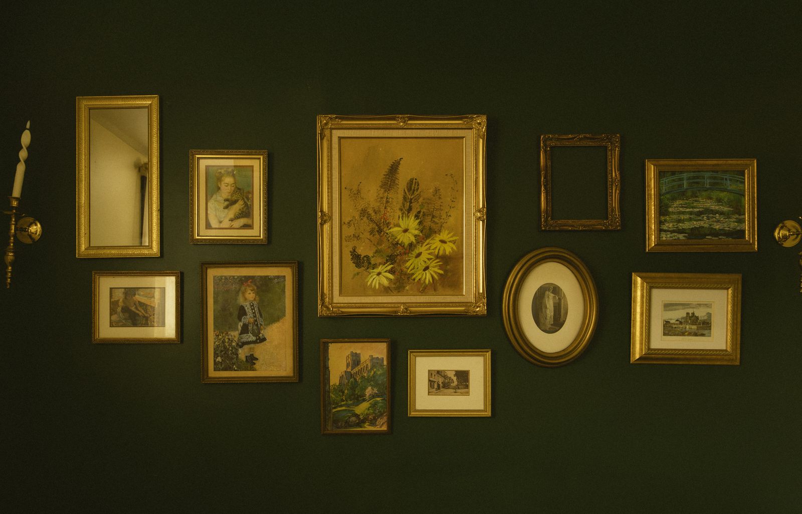 A wall of framed pictures in the main haus